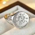 Detail view of a sterling silver zodiac signet ring featuring crescent moon and sparkling zircon stones. - Size 6 / Silver