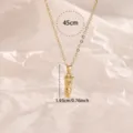 Golden bullet pendant necklace with chain detail, minimalist jewelry close-up view - Gold