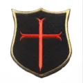 Embroidered tactical shield patch with red cross, black and gold border, durable hook backing. - Shield Crusader / Black