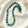 Green acrylic beaded necklace with gold metal spacer beads, elegant collarbone chain detail. - Green Marble Pattern
