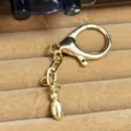Gold plated keychain pendant metal clasp bag charm accessory hardware detail view - Letter I