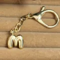 Gold-plated bubble letter M keychain pendant bag charm stylish metallic accessory. - Letter M