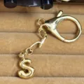 Gold-plated bubble letter S keychain pendant, stylish metal bag charm and key ring accessory. - Letter S