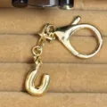 Gold bubble letter U keychain and bag charm, elegant metallic finish for stylish accessories. - Letter U
