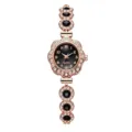 Detailed view of rose gold women's bracelet watch with rhinestones and black gems - Rhinestone Black Gem Floral Bracelet Style / Black