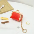 Red PU leather mini kiss-lock coin purse with gold chain, compact jewelry storage bag for rings. - Red