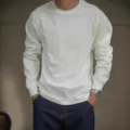 Detail shot of white heavy cotton raglan long sleeve shirt with model wearing casual denim. - S / Tops / White