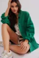 Detailed view of a casual green denim jacket showcasing classic collar and front button closure. - S / Green