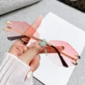 Chic rimless polygon sunglasses with gradient pink lenses and stylish gold metal accents. - Rimless Polygon / Gold Frame Double Pink