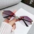 Trendy rimless polygonal sunglasses with gradient purple lenses and chic gold claw decor. - Rimless Polygon / Gold Frame Double Grey
