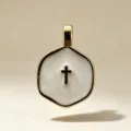 Elegant gold-toned hexagonal pendant with white enamel inlay and central cross motif. - White Cross (Pendant Only)