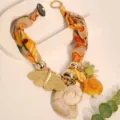 Detailed view of bohemian silk scarf necklace with metal butterfly and shell pendants - Yellow (X-890)