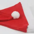 Red non-woven fabric Santa Claus hat with white plush pom-pom for holiday party decor. - Kids (25x35cm) / Standard Non-woven Fabric / Red