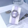 Detail view of women quartz watch featuring purple leather strap and rhinestone bezel design. - Purple