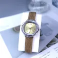 Detail shot of women quartz watch with crystal floral bezel and brown leather strap. - Tan