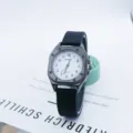 Detailed view of the minimalist square quartz watch with black silicone strap and dial numbers. - Black