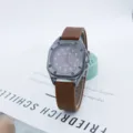 Square dial quartz watch with brown silicone strap, detail view of student style wristwatch. - Coffee