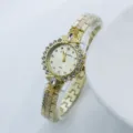 Women's gold quartz watch with dazzling rhinestones and elegant metallic strap design. - Gold Gold