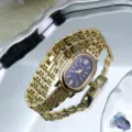 Close-up detail of a vintage oval rhinestone gold quartz watch with stylish chain strap. - Gold Black