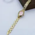 Vista detallada de reloj de cuarzo vintage ovalado con diamantes de imitación y cadena. - Rosa