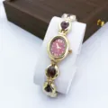 Chic women's quartz bracelet watch featuring an elegant red oval dial and stylish gold band. - Red