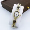 Elegant gold quartz watch for women with oval dial and chic chain bracelet design. - Coffee