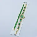 Orologio donna al quarzo dorato e bracciale tennis con cristalli verdi, set elegante. - Verde