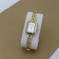 Gold tone quartz bracelet watch for women with stylish rectangular dial and hollow bangle strap. - White