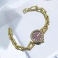 Detail of women quartz watch with unique chain strap, rhinestone bezel, and lobster clasp. - Red