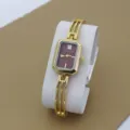 Gold-tone rectangular dial quartz watch for women with stylish bracelet strap, detailed view. - Red