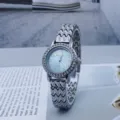 Detailed shot of a stylish women's quartz watch featuring a rhinestone bezel and silver wavy strap. - Silver Blue