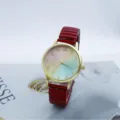 Close-up detail shot of a fashion women quartz watch with colorful gradient dial and red band. - Red
