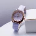 Detail shot of square quartz watch featuring purple leather strap and rhinestone bezel. - Purple