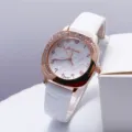 Close-up detail of the luxury square rhinestone quartz watch with white leather strap. - White