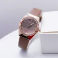 Detail view of women quartz watch featuring rhinestone bezel and brown PU leather strap. - Coffee