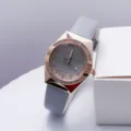 Detail shot of elegant women quartz watch featuring sparkling rhinestone bezel and grey leather strap. - Gray