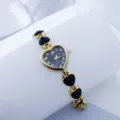 Elegante hartvormige quartz dameshorloge met zwarte wijzerplaat en stijlvolle schakelband. - Goud Zwart