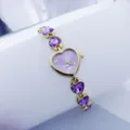 Detail shot of a purple heart quartz watch with crystal bracelet, elegant accessory. - Gold Purple