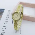 Elegant gold quartz watch with rhinestone bezel and leaf metal strap for women fashion style. - Gold