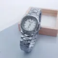 Detail shot of women square rhinestone watch dial and steel strap, close-up view. - Silver White
