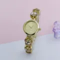 Elegant gold quartz watch featuring sparkling crystal butterfly charms on the delicate bracelet. - Gold Gold
