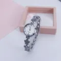 Women fashion clover quartz watch with exquisite silver bracelet strap and clear dial digits. - Silver White