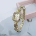 Close-up shot of a luxurious gold quartz square rhinestone watch with sparkling crystals. - Gold