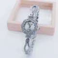Close-up detail of the rhinestone flower dial quartz watch, highlighting sparkly crystal bracelet. - Silver