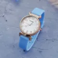 Close-up detail shot of light blue silicone strap quartz watch featuring a white digital dial. - Sky Blue