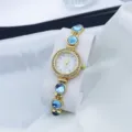 Elegante dames quartz horloge met blauwe kralen armband en sprankelende strass wijzerplaat. - Blauw