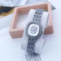 Detailed close-up view of elegant square rhinestone quartz women watch with silver link metal strap. - Silver White