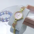 Dames gouden quartz horloge met roze wijzerplaat en sprankelende kristallen vlinder schakels. - Goud & Roze