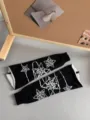 Detailed view of black and white knitted leg warmers with star patterns, Y2K aesthetic knitwear. - White Meteor (Black Base) / White