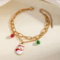 Bracciale in acciaio dorato a doppia catena con ciondolo pupazzo di neve e campanelli festivi. - Pupazzo di neve